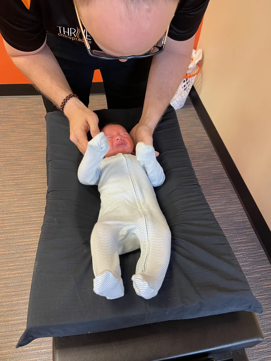 Dr. Rubinstein performing a gentle adjustment on a newborn.